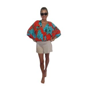 Red and turquoise women's top with elastic waist. V neck overlapping collar.
